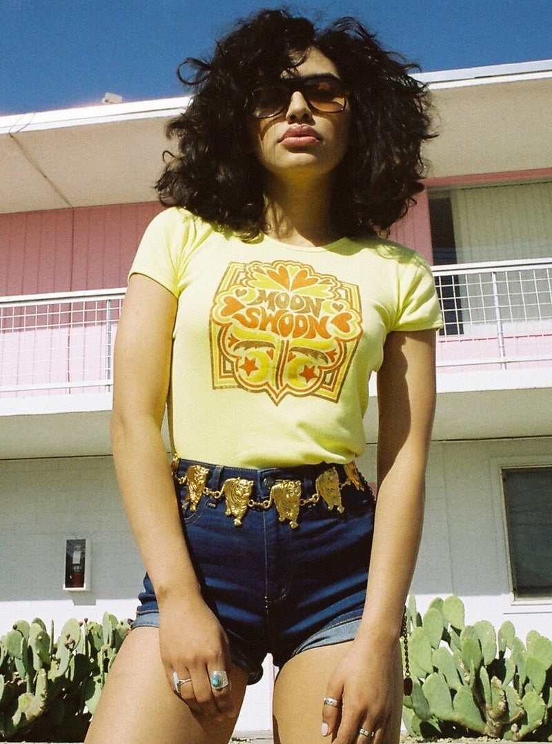 Model wearing yellow vintage inspired tee from Top Knot Goods that says Moon Swoon